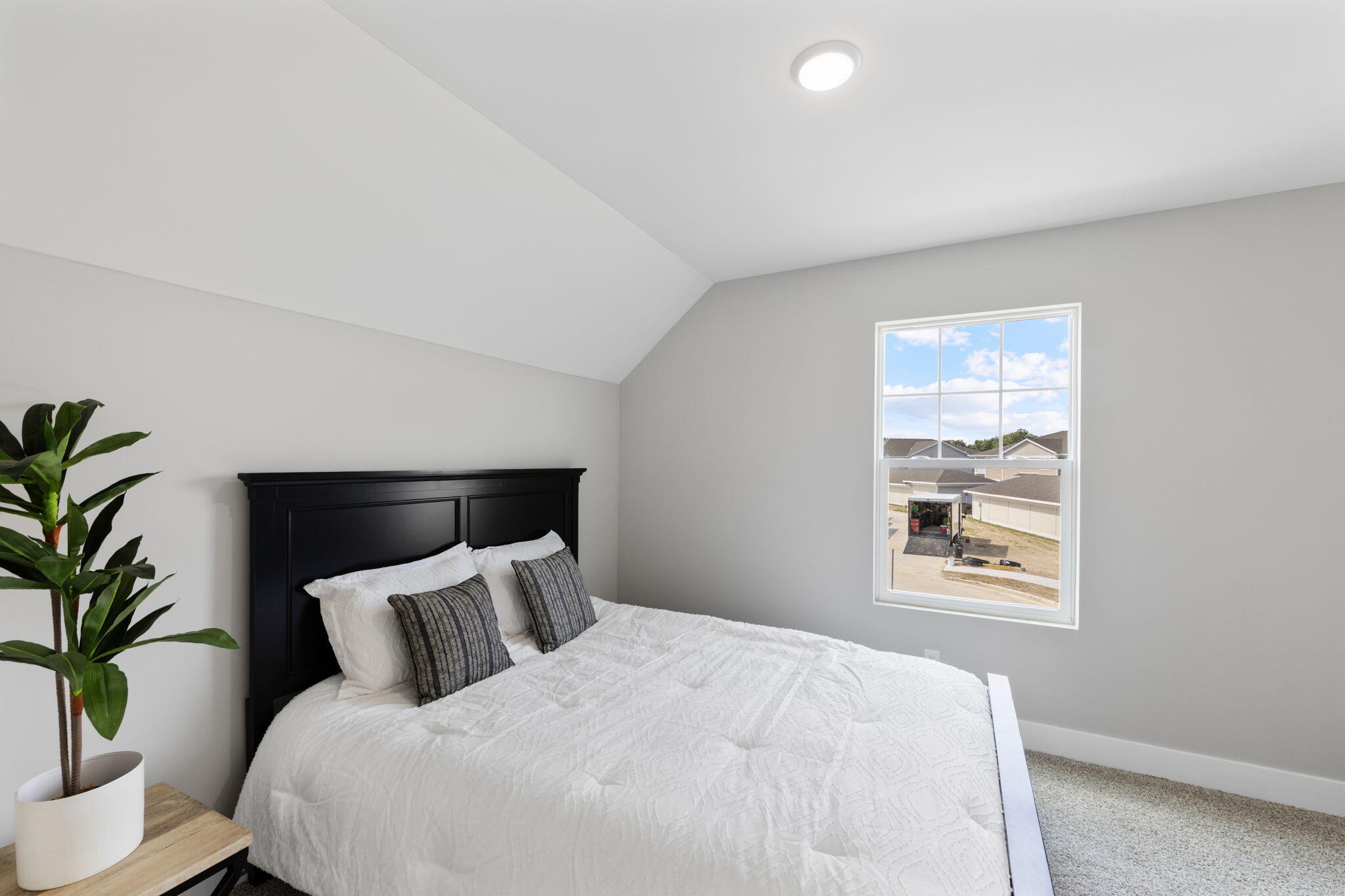 1183 Harbor Way Chesterton, IN 46304 - Photo 19 of 20 a large bed sitting in a bedroom next to a window with potted plant