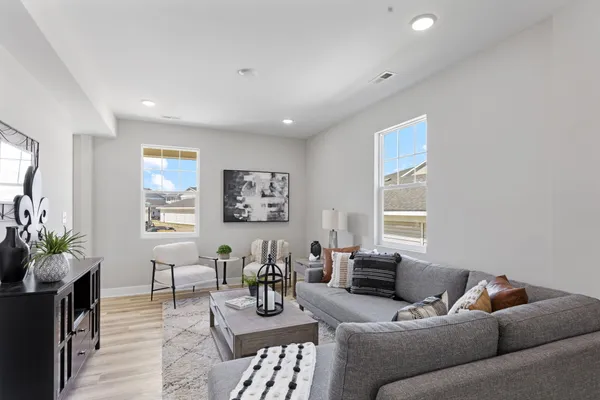a living room with furniture and a potted plant