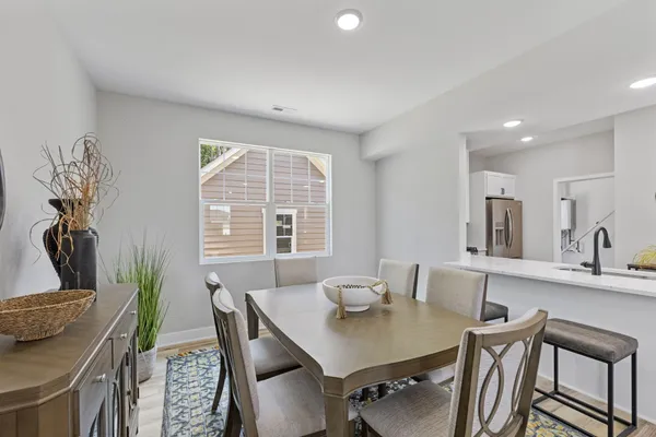 a view of a dining room with furniture and a potted plant