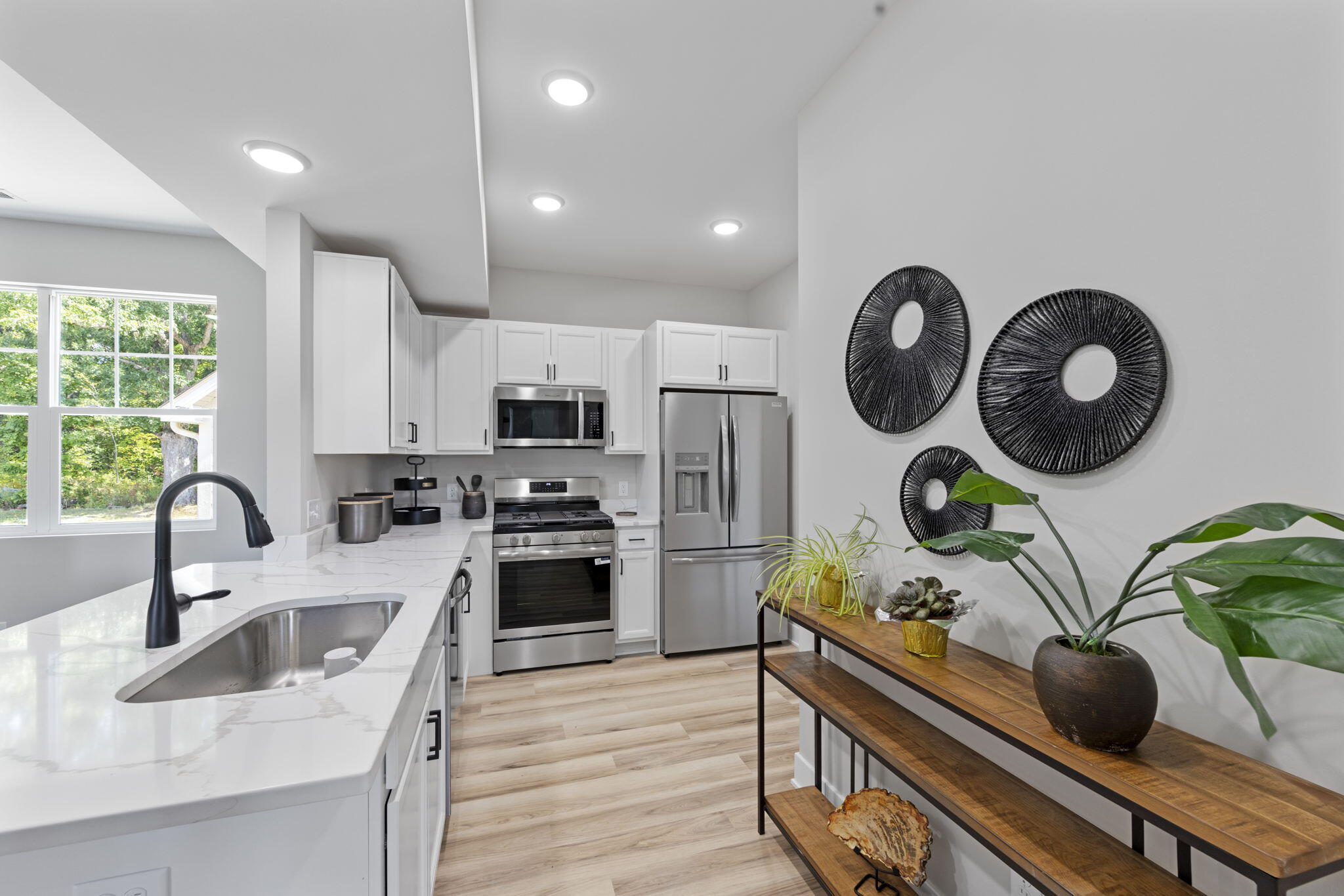 1183 Harbor Way Chesterton, IN 46304 - Photo 10 of 20 a kitchen with stainless steel appliances a sink a stove top oven a clock and cabinets