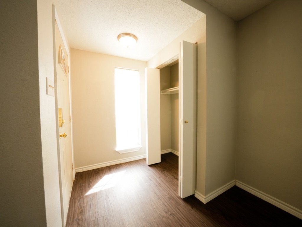 7312 Providence Avenue Austin, TX 78752 - Photo 13 of 22 an empty room with wooden floor and closet