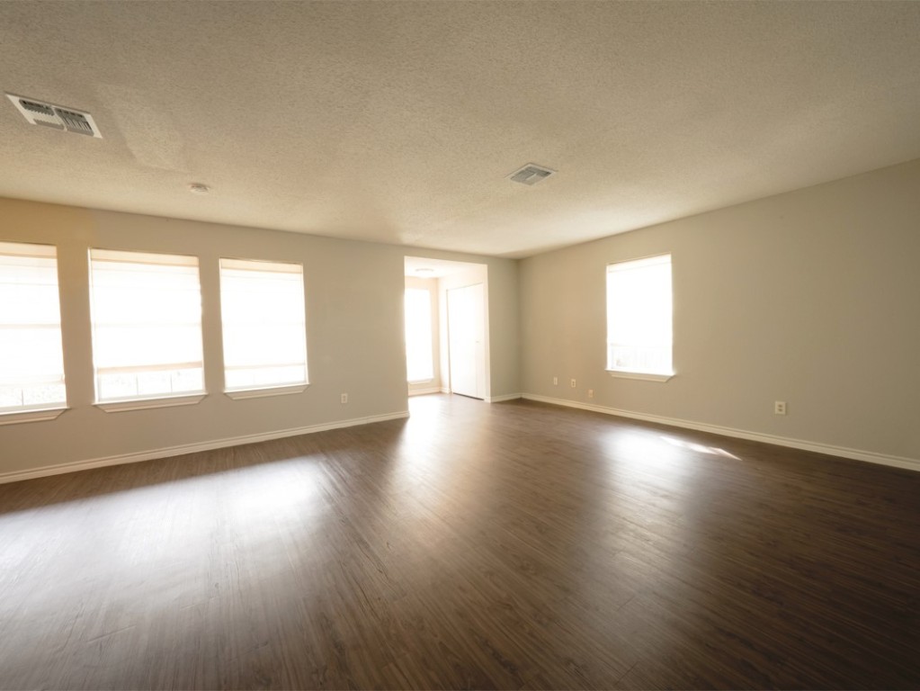 7312 Providence Avenue Austin, TX 78752 - Photo 16 of 22 a view of an empty room with wooden floor and window