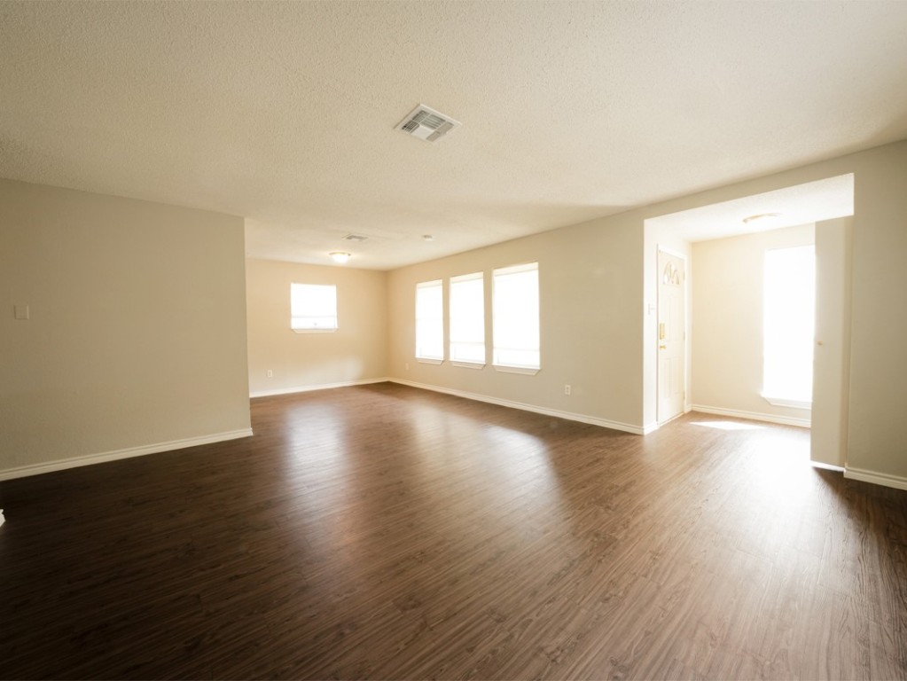 7312 Providence Avenue Austin, TX 78752 - Photo 6 of 22 wooden floor in an empty room with a window