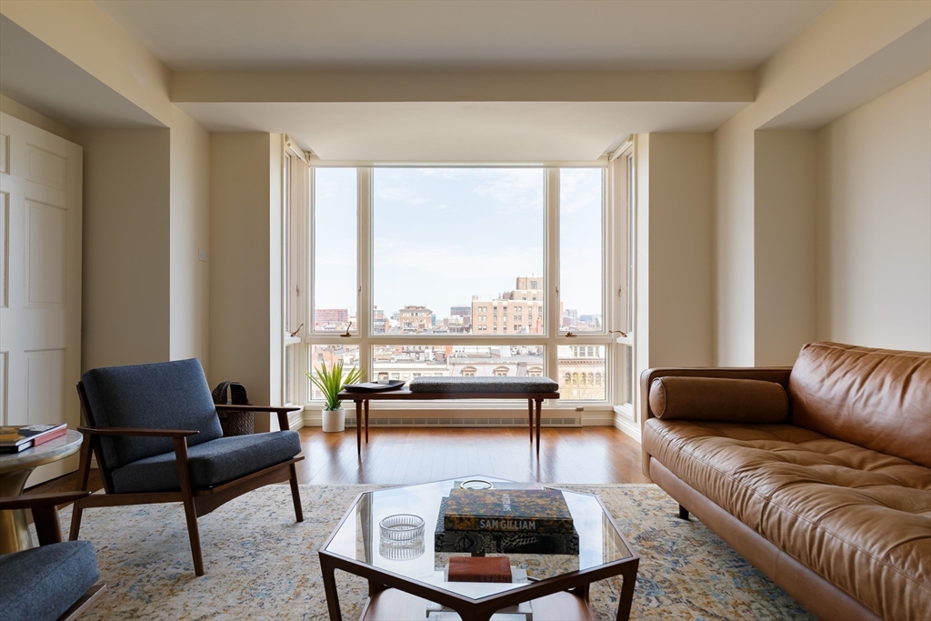 2 Commonwealth Avenue, Unit 8G Boston, MA 02116 - Photo 2 of 20 a living room with furniture and a large window