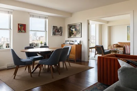 a dining room with furniture a window and wooden floor