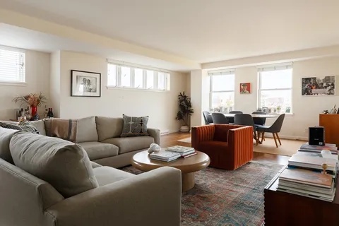 a living room with furniture a couch and a window