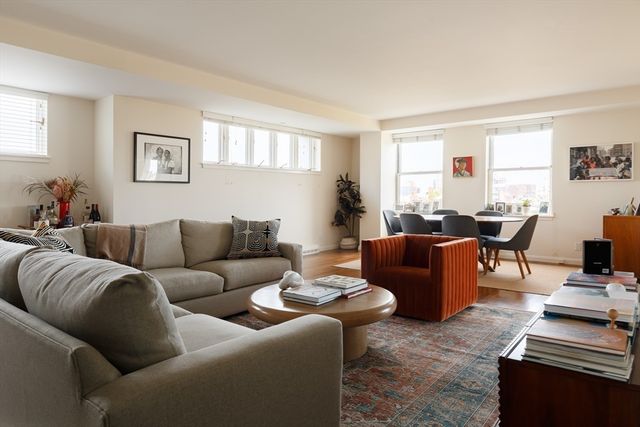 a living room with furniture a couch and a window