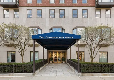 a view of a brick house with many windows