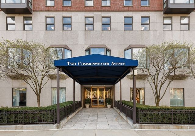 a view of a brick house with many windows