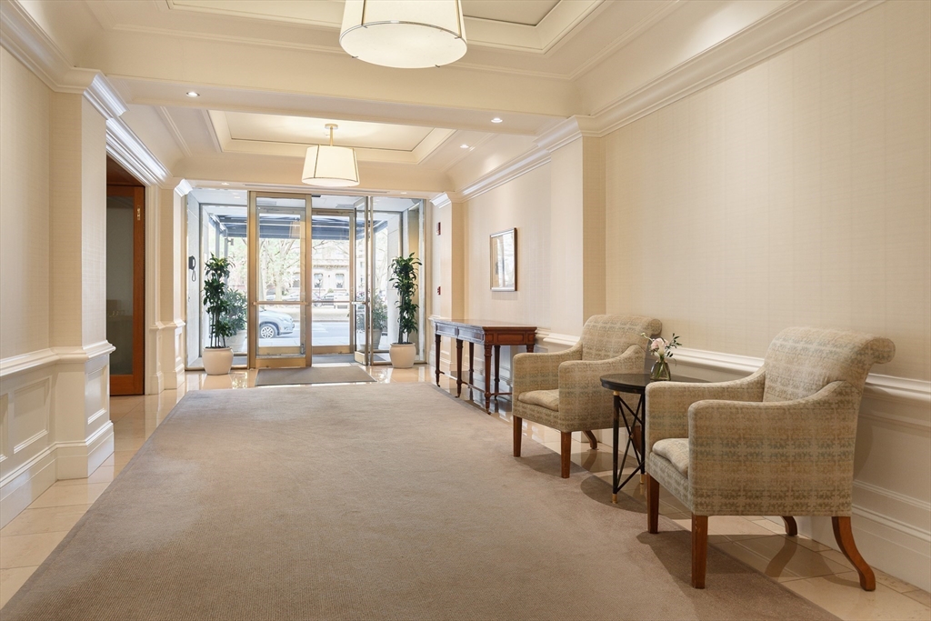2 Commonwealth Avenue, Unit 8G Boston, MA 02116 - Photo 10 of 20 a living room with furniture and a large window