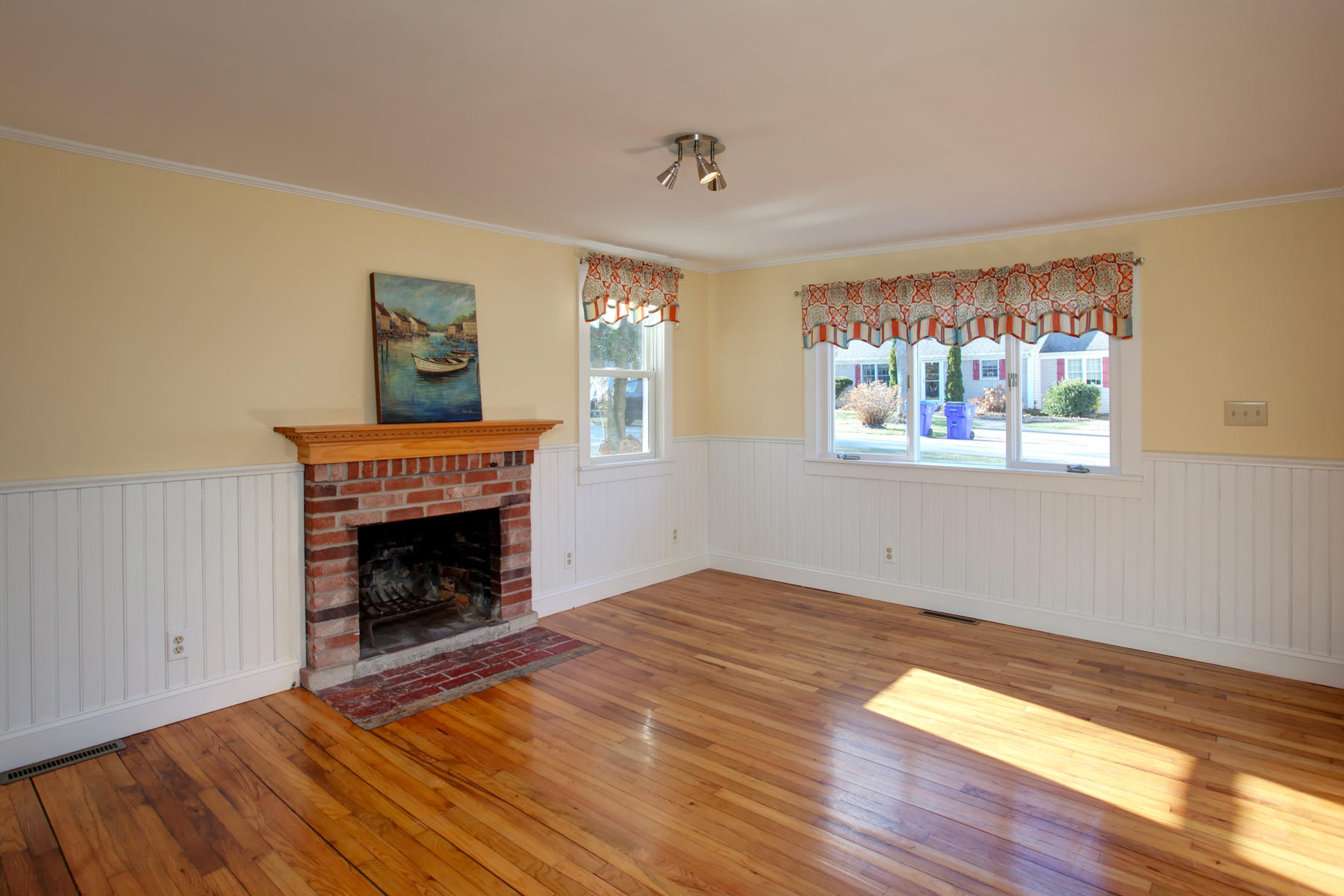 46 Thorne Road Bourne, MA 02532 - Photo 16 of 32 a view of empty room with wooden floor and fireplace
