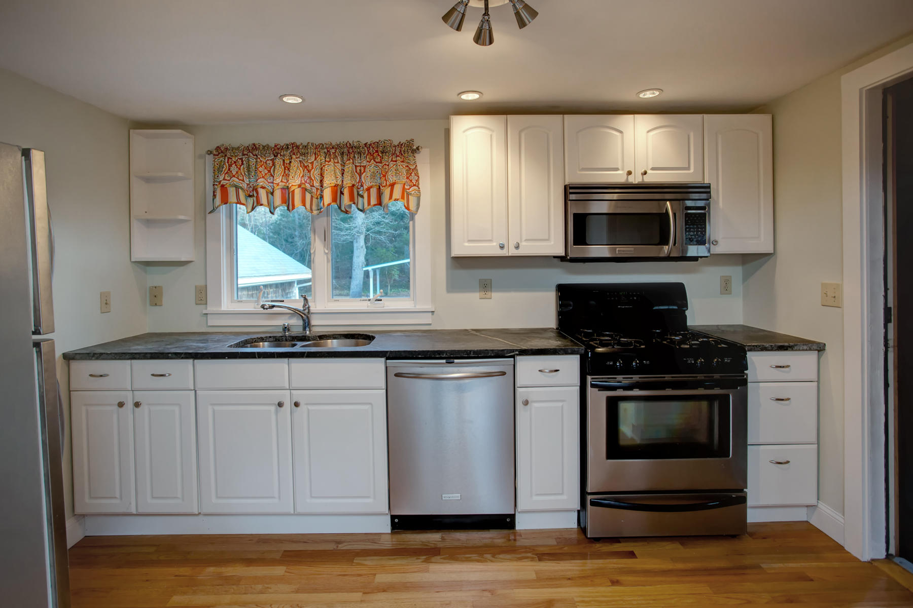 46 Thorne Road Bourne, MA 02532 - Photo 18 of 32 a kitchen with stainless steel appliances granite countertop a stove a microwave and a sink