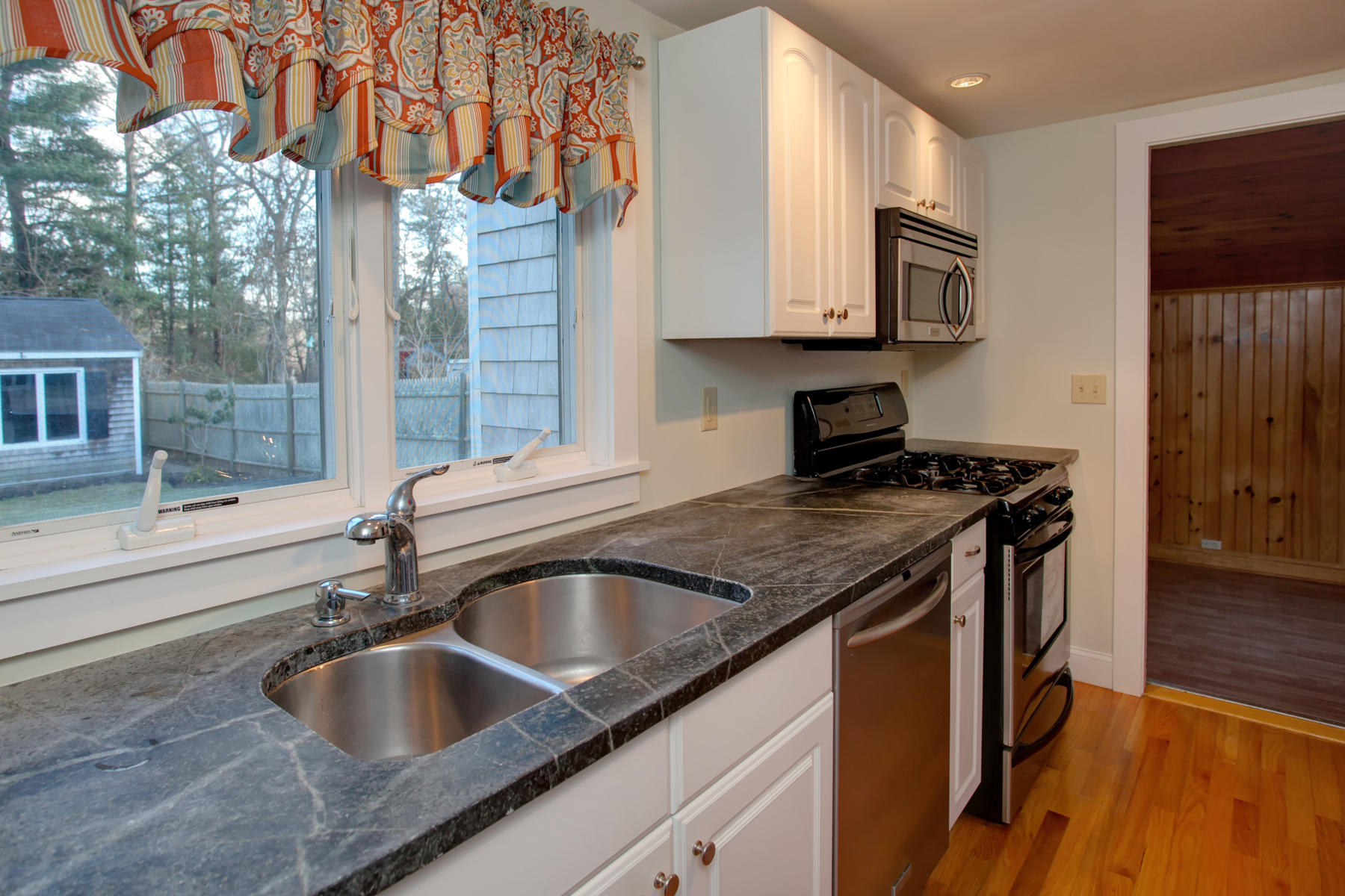 46 Thorne Road Bourne, MA 02532 - Photo 21 of 32 a kitchen with granite countertop a sink and a stove top oven