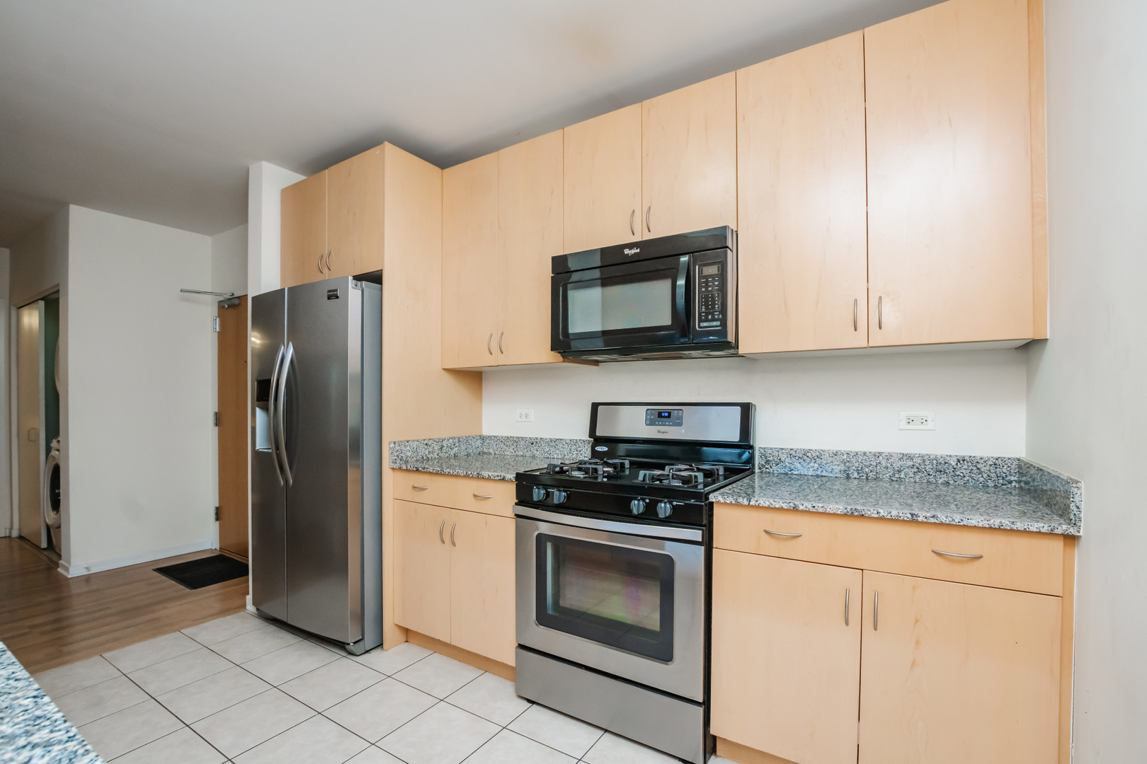 7243 Madison Street, Unit 310 Forest Park, IL 60130 - Photo 5 of 23 a kitchen with stainless steel appliances granite countertop a refrigerator stove and microwave