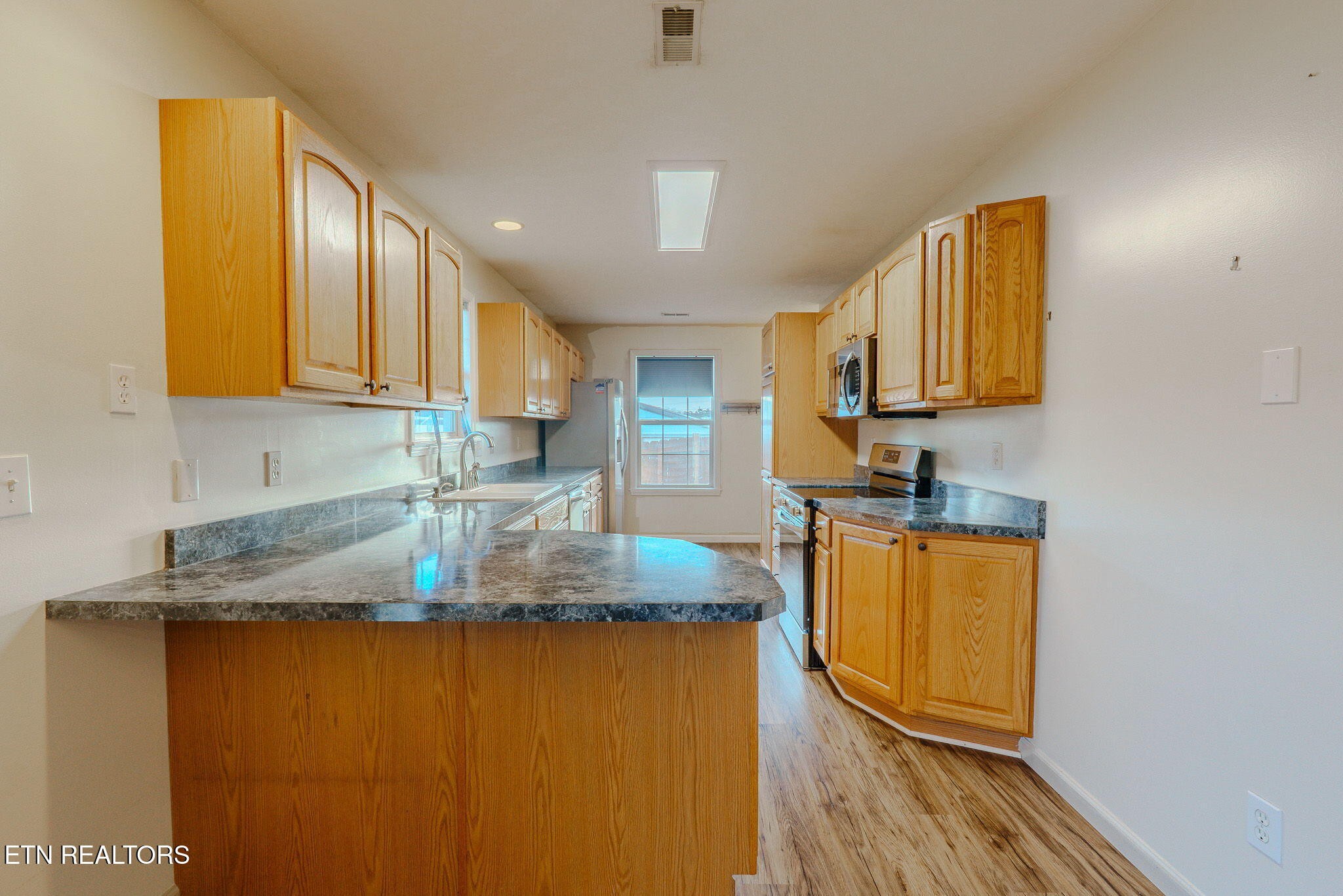 6622 Carina Lane Corryton, TN 37721 - Photo 12 of 30 a kitchen with granite countertop cabinets and stainless steel appliances