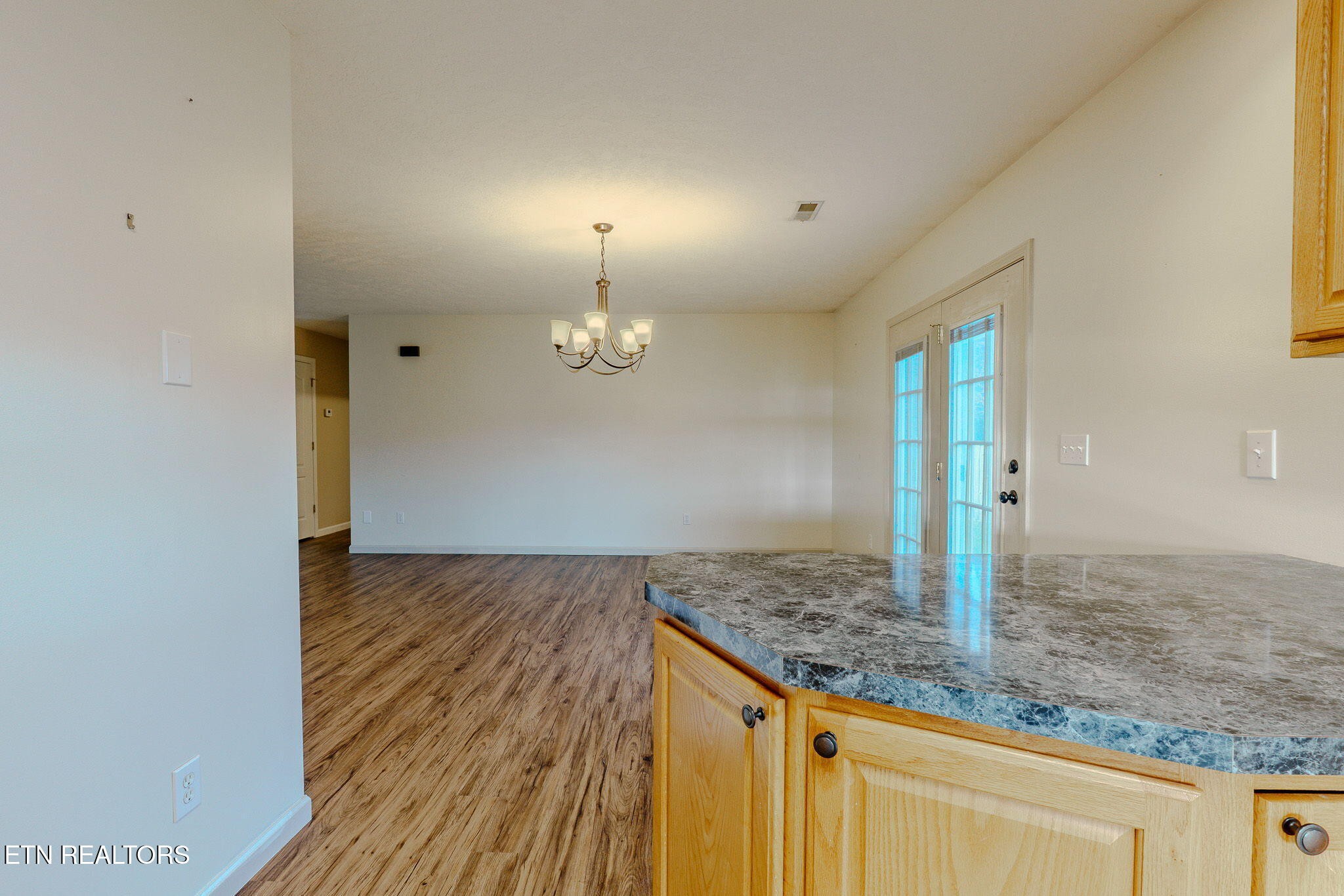 6622 Carina Lane Corryton, TN 37721 - Photo 15 of 30 an empty room with kitchen appliances and wooden floor