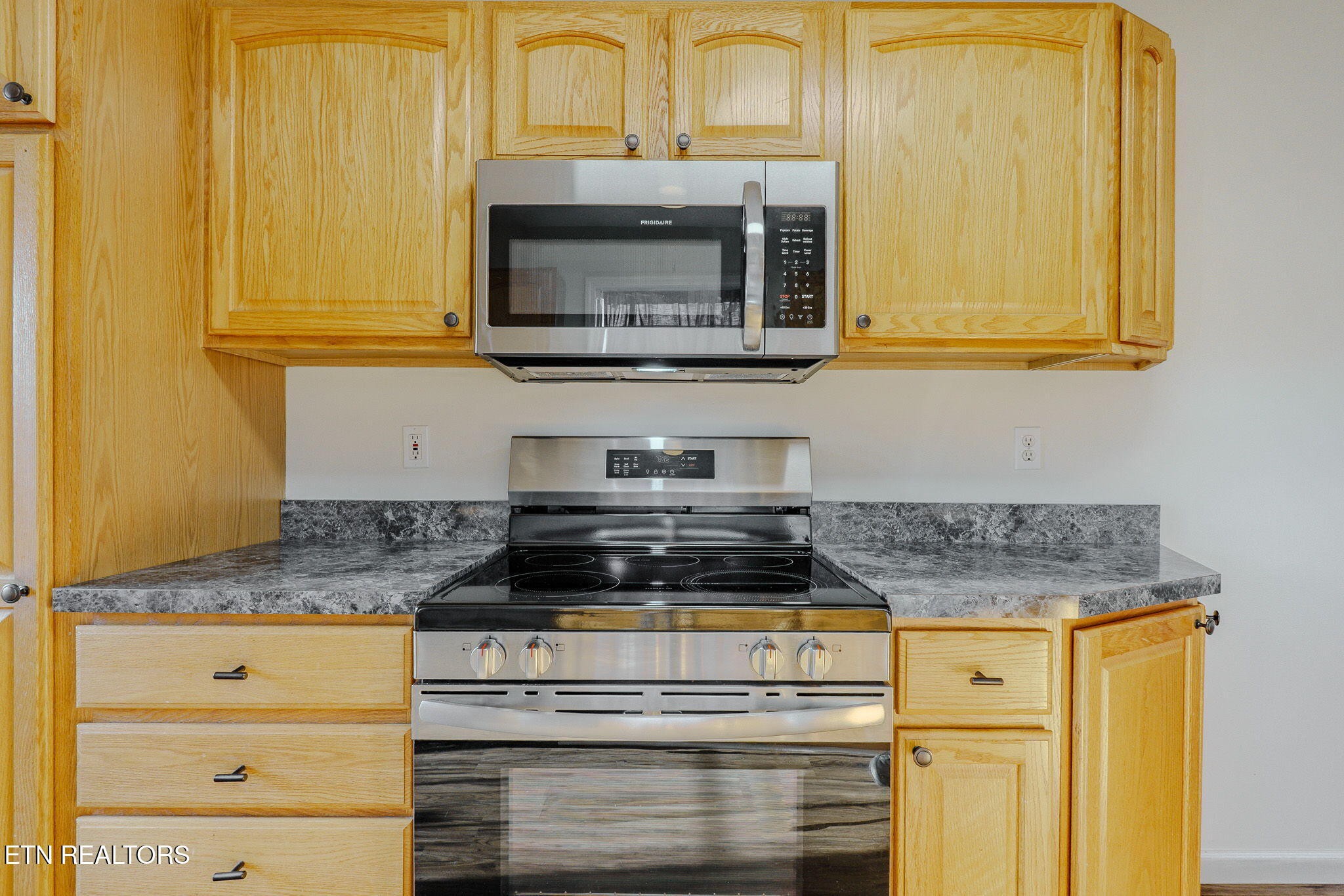 6622 Carina Lane Corryton, TN 37721 - Photo 16 of 30 a kitchen with granite countertop cabinets stainless steel appliances and a counter space