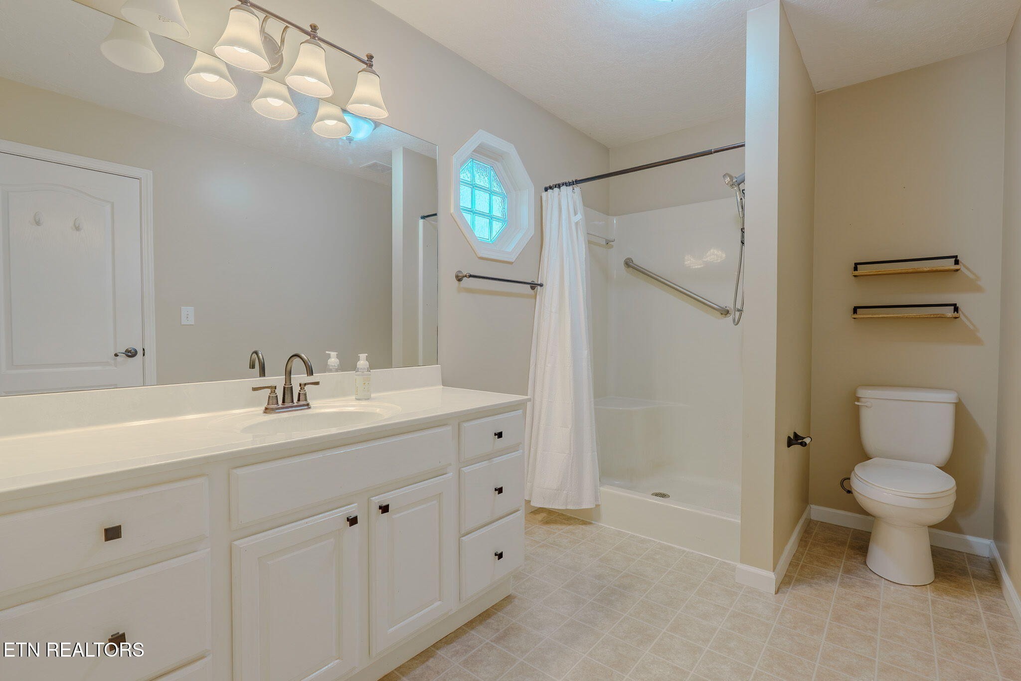 6622 Carina Lane Corryton, TN 37721 - Photo 23 of 30 a bathroom with a toilet sink and mirror