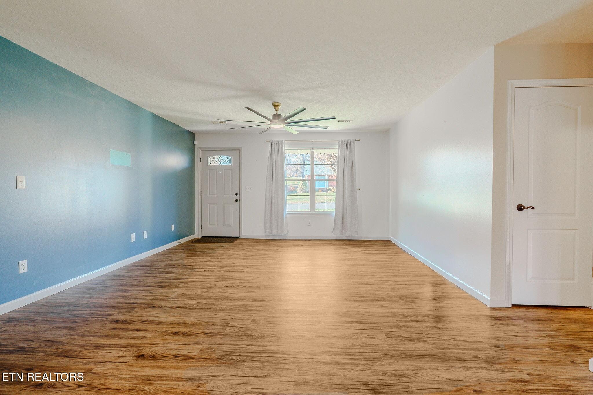 6622 Carina Lane Corryton, TN 37721 - Photo 8 of 30 a view of an empty room with wooden floor and a window