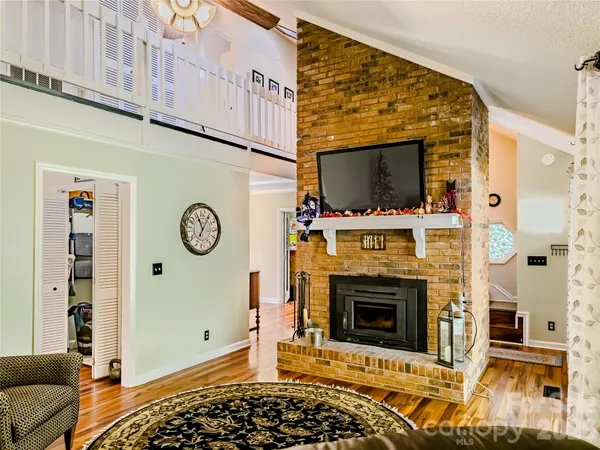 a view of a livingroom with a fireplace and workspace