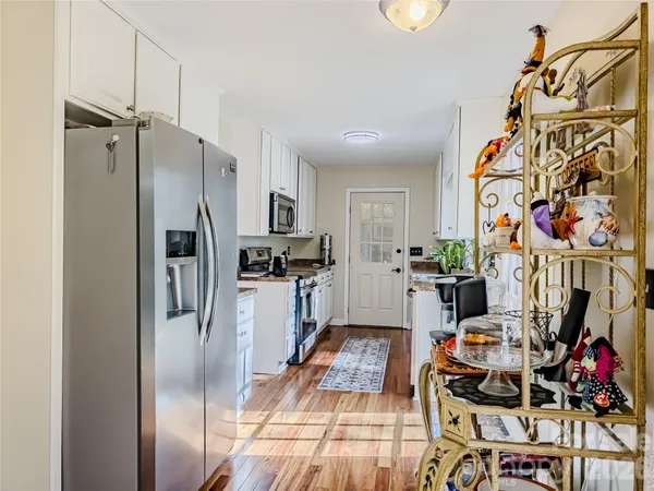 a kitchen with stainless steel appliances granite countertop a refrigerator and a sink