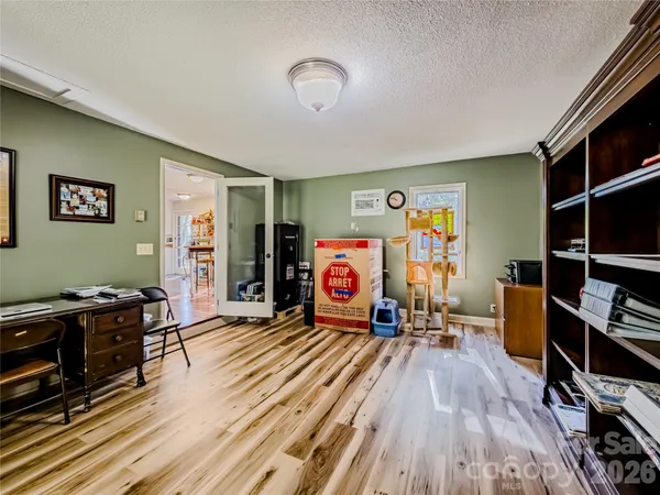 a view of a room with furniture and wooden floor