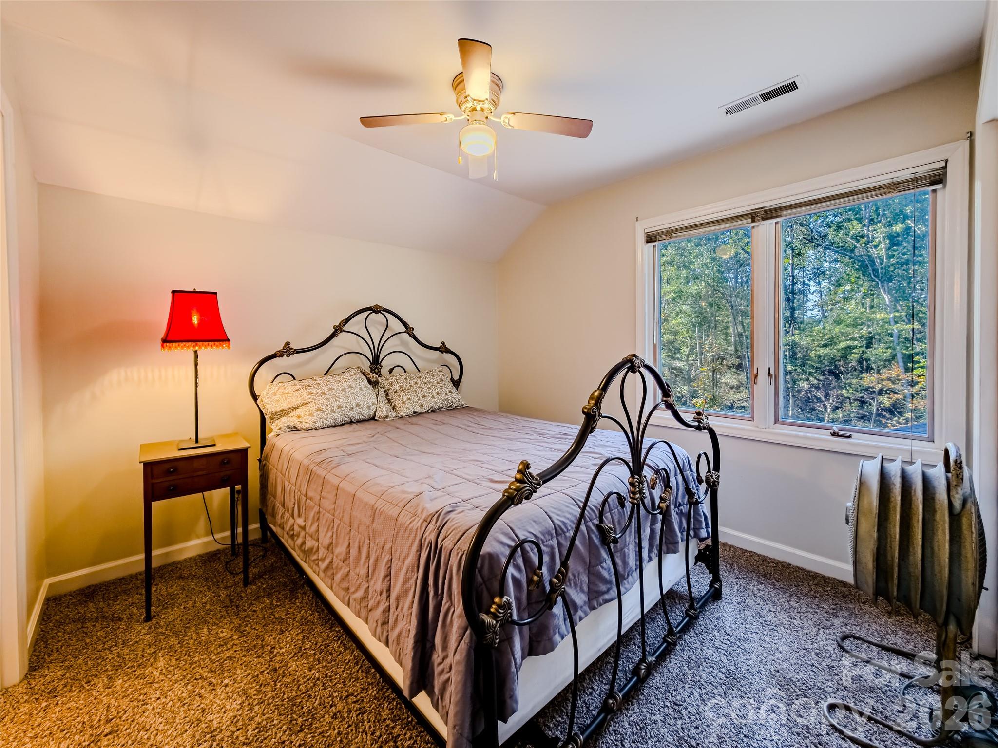 142 Padgett And Burns Road Forest City, NC 28043 - Photo 28 of 48 a bedroom with a bed and a chandelier