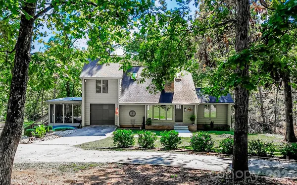 an aerial view of house with yard and car parked