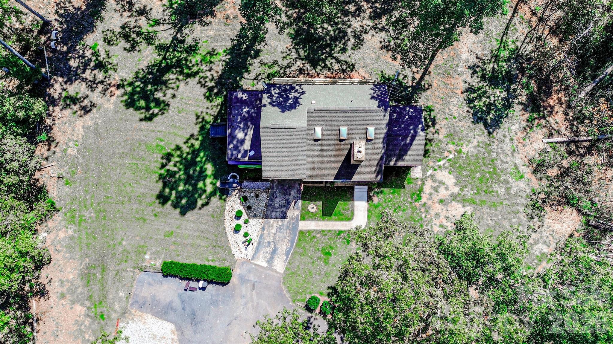 142 Padgett And Burns Road Forest City, NC 28043 - Photo 47 of 48 an aerial view of a house with a yard and large trees