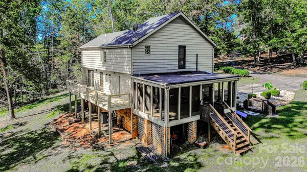 a view of a house with wooden deck front of house