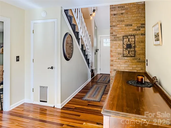 a view of a entryway door with wooden floor
