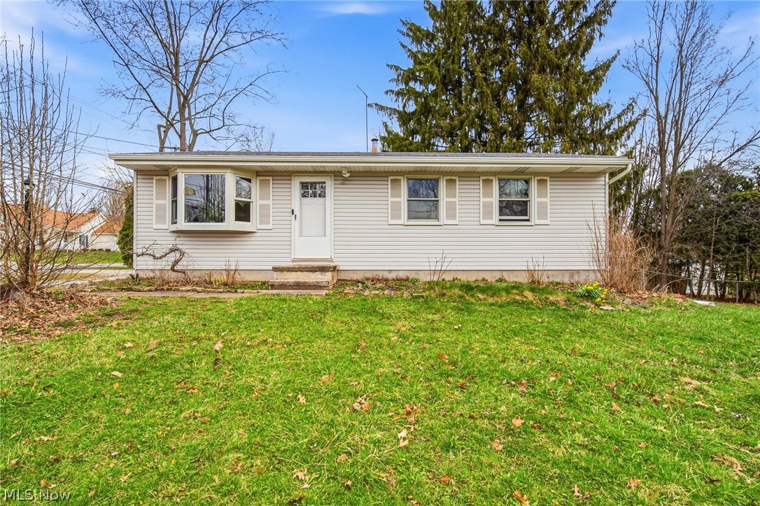 Single story home with a front yard on a corner lot.