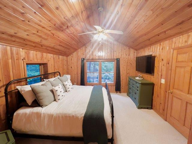 893 Hooper Road Cleveland, GA 30528 - Photo 21 of 68 a bedroom with a bed a flat screen tv and a chandelier