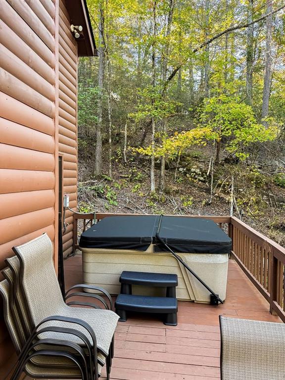 893 Hooper Road Cleveland, GA 30528 - Photo 50 of 68 a view of a balcony with chairs and wooden floor