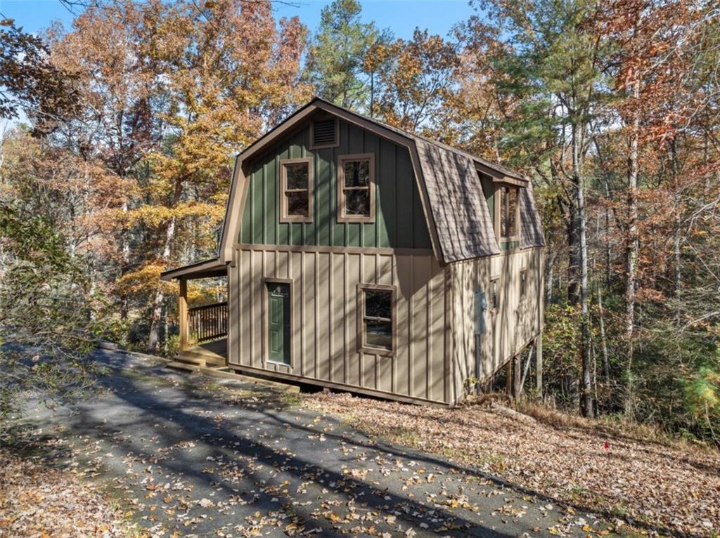893 Hooper Road Cleveland, GA 30528 - Photo 5 of 68 a view of a wooden house with large trees