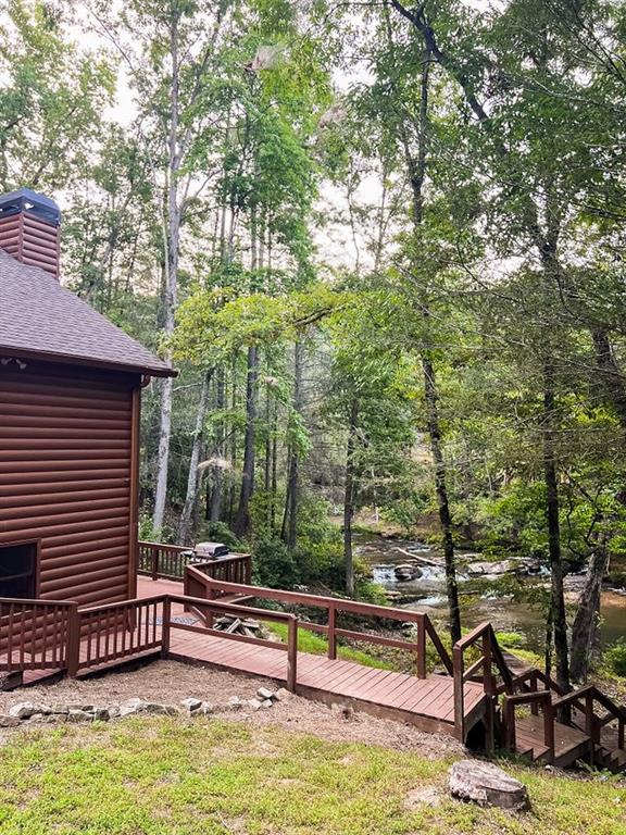 893 Hooper Road Cleveland, GA 30528 - Photo 8 of 68 a view of a swimming pool with a bench and trees