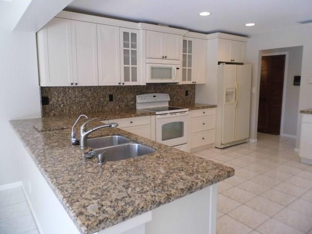 610 Southwest 17th Street Boca Raton, FL 33486 - Photo 1 of 49 a kitchen with stainless steel appliances granite countertop a sink stove and refrigerator