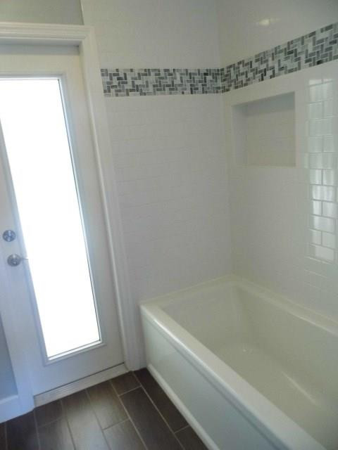 610 Southwest 17th Street Boca Raton, FL 33486 - Photo 14 of 49 a bathroom with a bathtub and a window