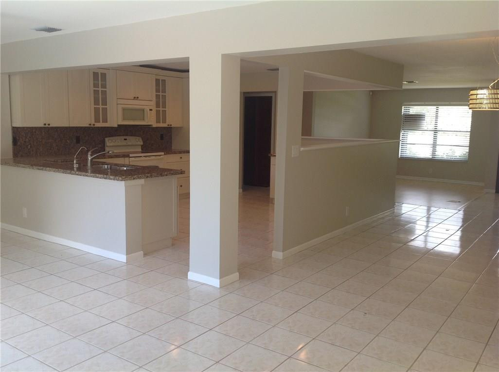 610 Southwest 17th Street Boca Raton, FL 33486 - Photo 34 of 49 a kitchen with granite countertop white cabinets and window