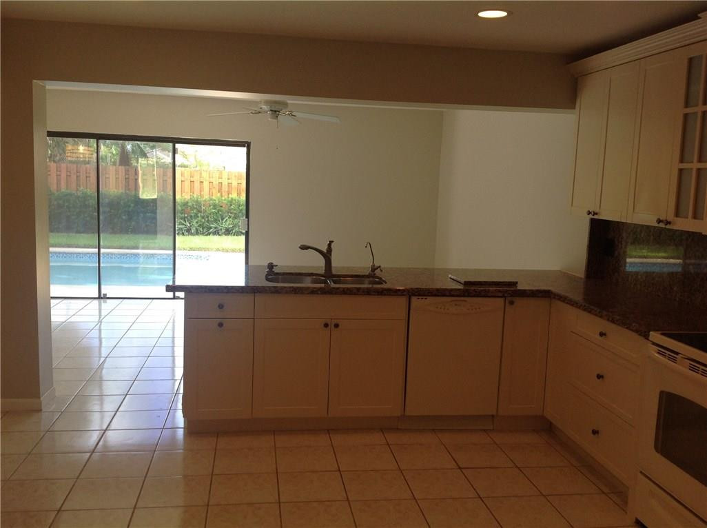610 Southwest 17th Street Boca Raton, FL 33486 - Photo 35 of 49 a kitchen with granite countertop a coffee table and a large window