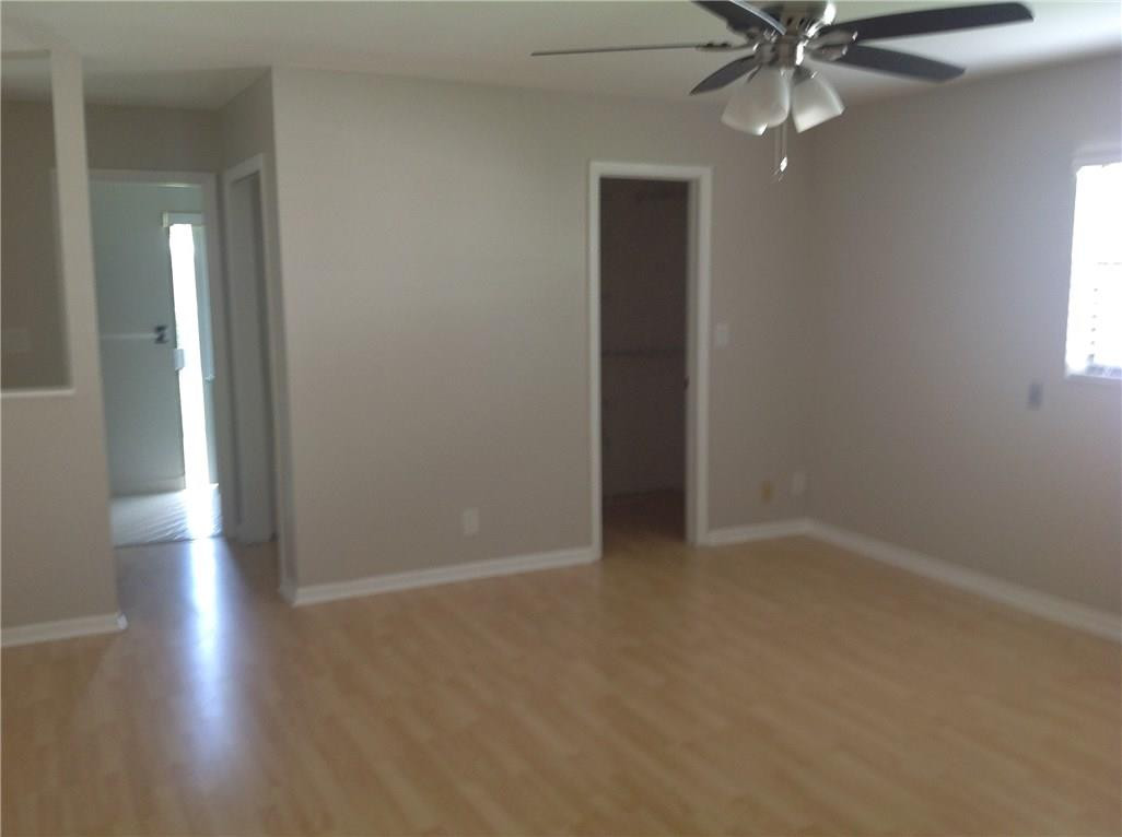 610 Southwest 17th Street Boca Raton, FL 33486 - Photo 38 of 49 an empty room with wooden floor fan and windows