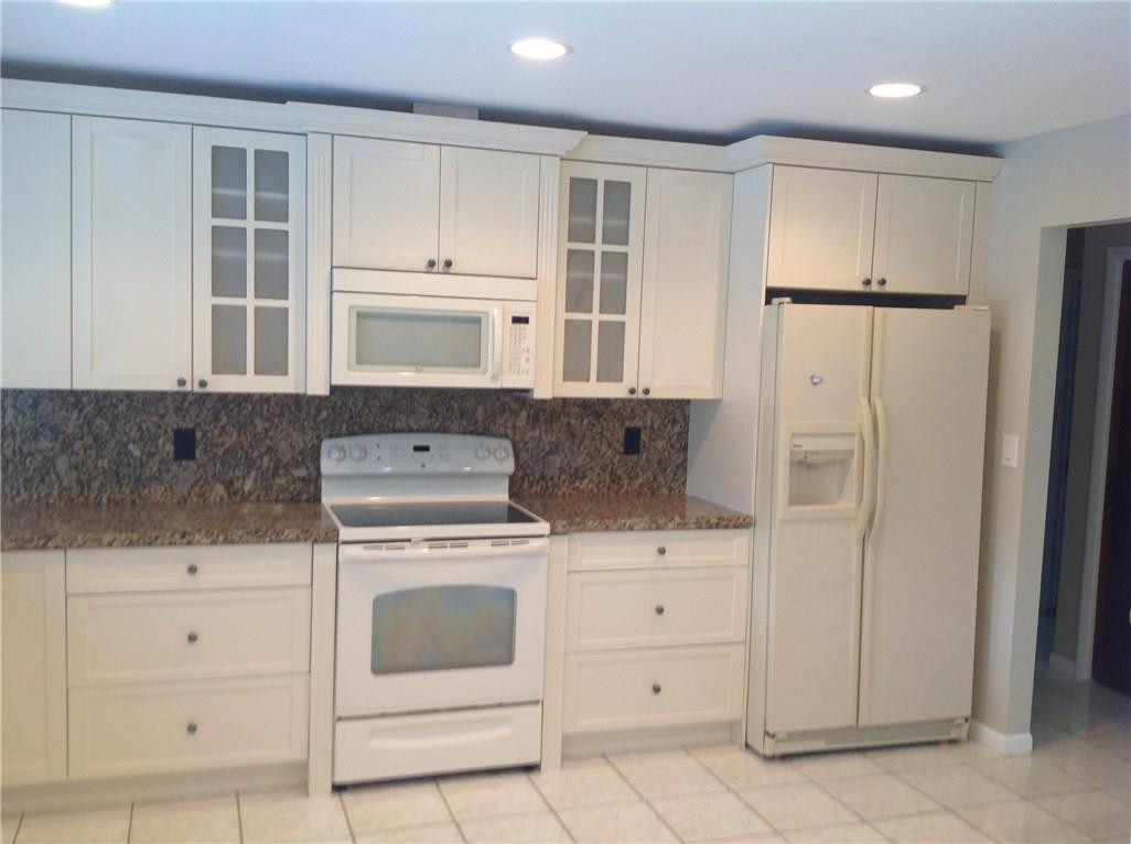 610 Southwest 17th Street Boca Raton, FL 33486 - Photo 44 of 49 a kitchen with white cabinets and white appliances