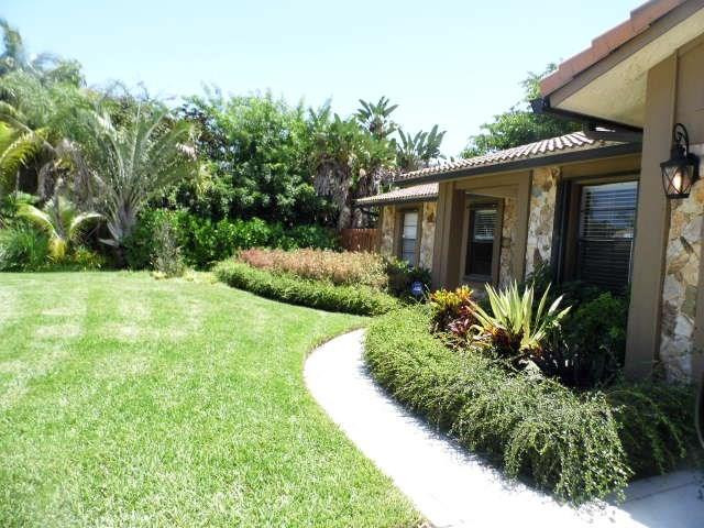 610 Southwest 17th Street Boca Raton, FL 33486 - Photo 47 of 49 a front view of a house with garden