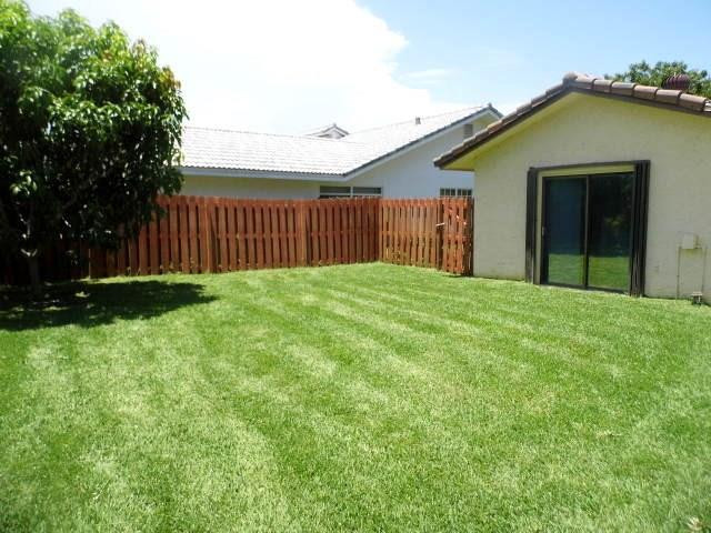 610 Southwest 17th Street Boca Raton, FL 33486 - Photo 5 of 49 a front view of a house with yard
