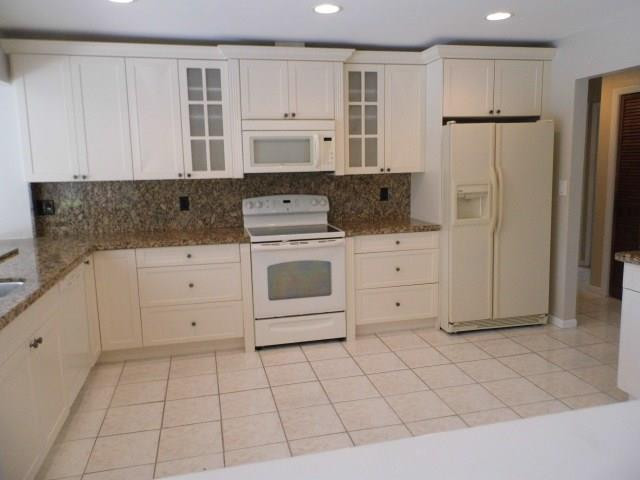 610 Southwest 17th Street Boca Raton, FL 33486 - Photo 7 of 49 a kitchen with white cabinets and refrigerator