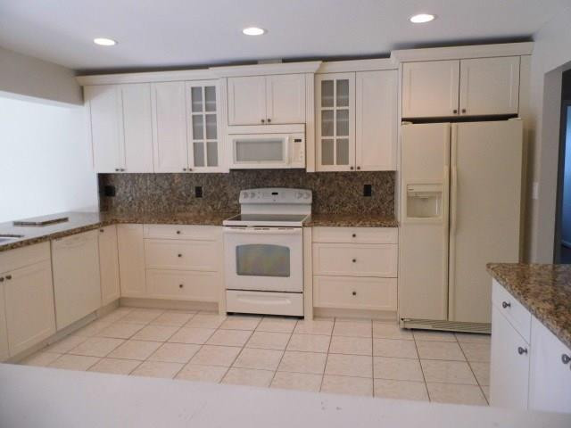 610 Southwest 17th Street Boca Raton, FL 33486 - Photo 8 of 49 a kitchen with white cabinets and white appliances