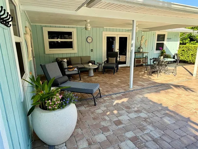 a view of patio with a table and chairs under an umbrella