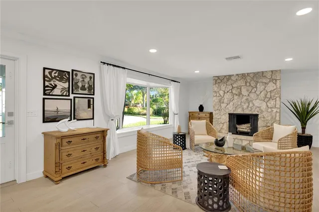a living room with furniture a fireplace and a flat screen tv