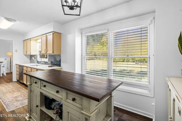 a view of a kitchen counter top a stove and a window