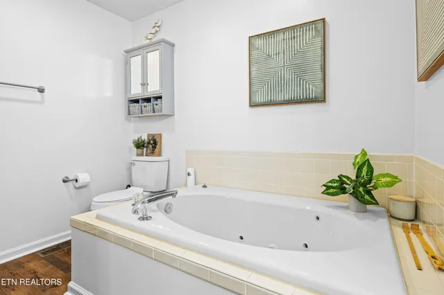 a bathroom with a sink a toilet and bathtub